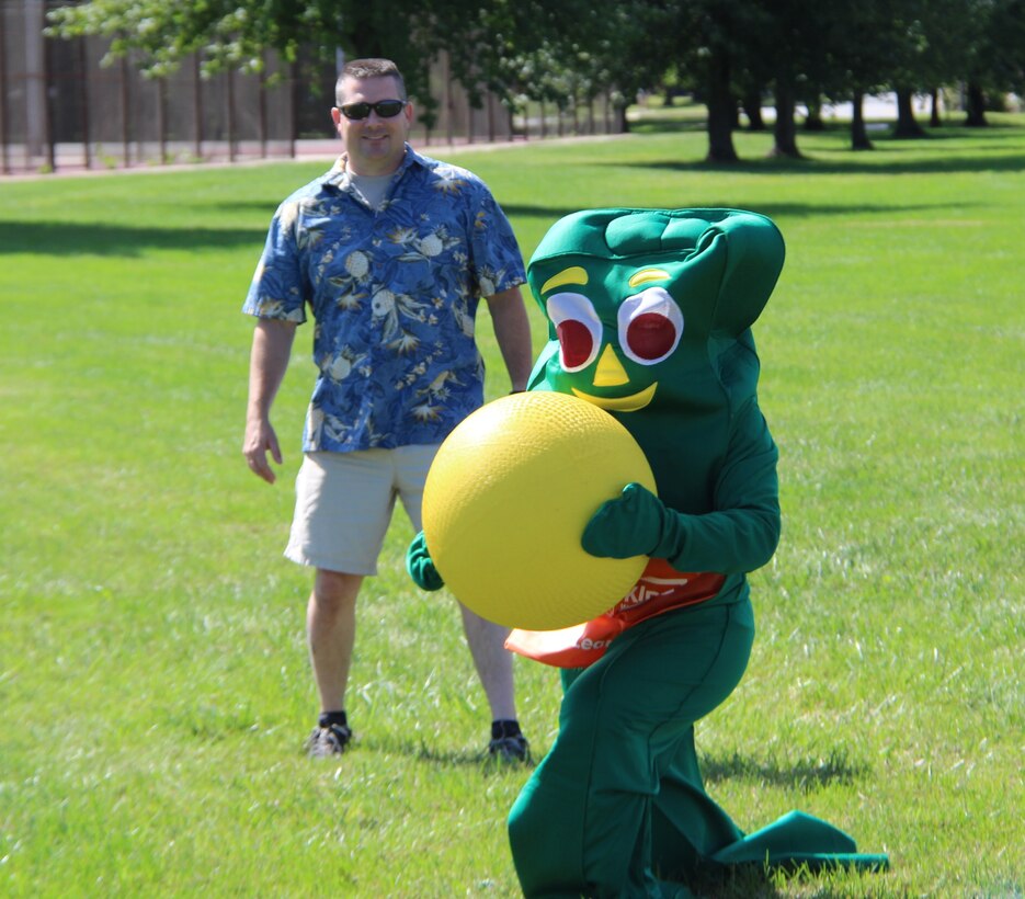 The commander of the 932nd Security Forces Squadron, Lt. Col. Edward Hunn, admires the amazing sports skills of a special "guest" outfielder at the recent family picnic day, which featured local Saint Louis super heroes and a unique kickball competition this year.  (U.S. Air Force photo by Maj. Stan Paregien)