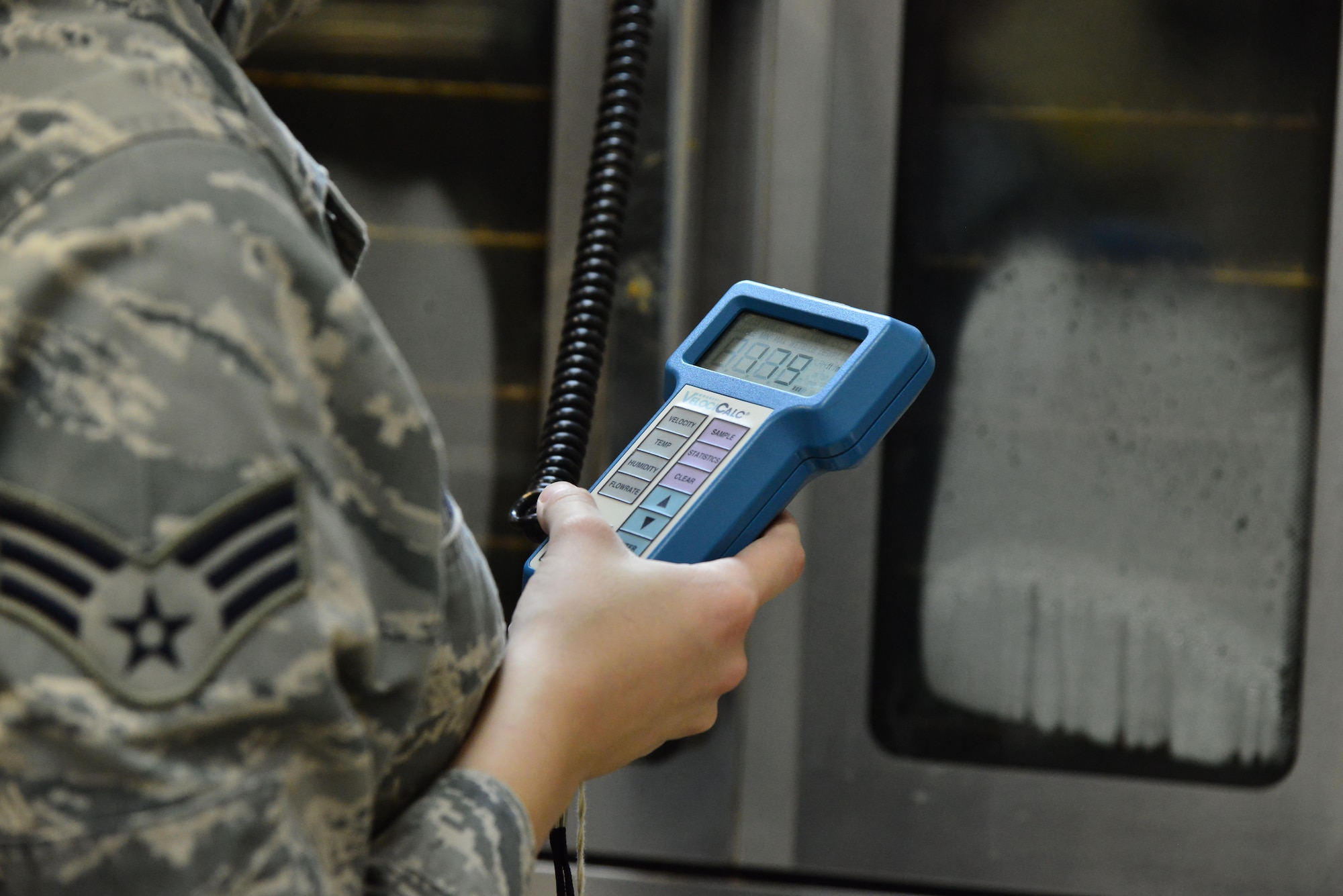Senior Airman Leah Smith, 379th Expeditionary Medical Operations Support Squadron Bioenvironmental, uses a Direct-Reading instrument to measure the flow rate of air that is being passed through the dining facility ventilation system September 30, 2015 at Al Udeid Air Base, Qatar. (U.S. Air Force photo/Staff Sgt. Alexandre Montes)