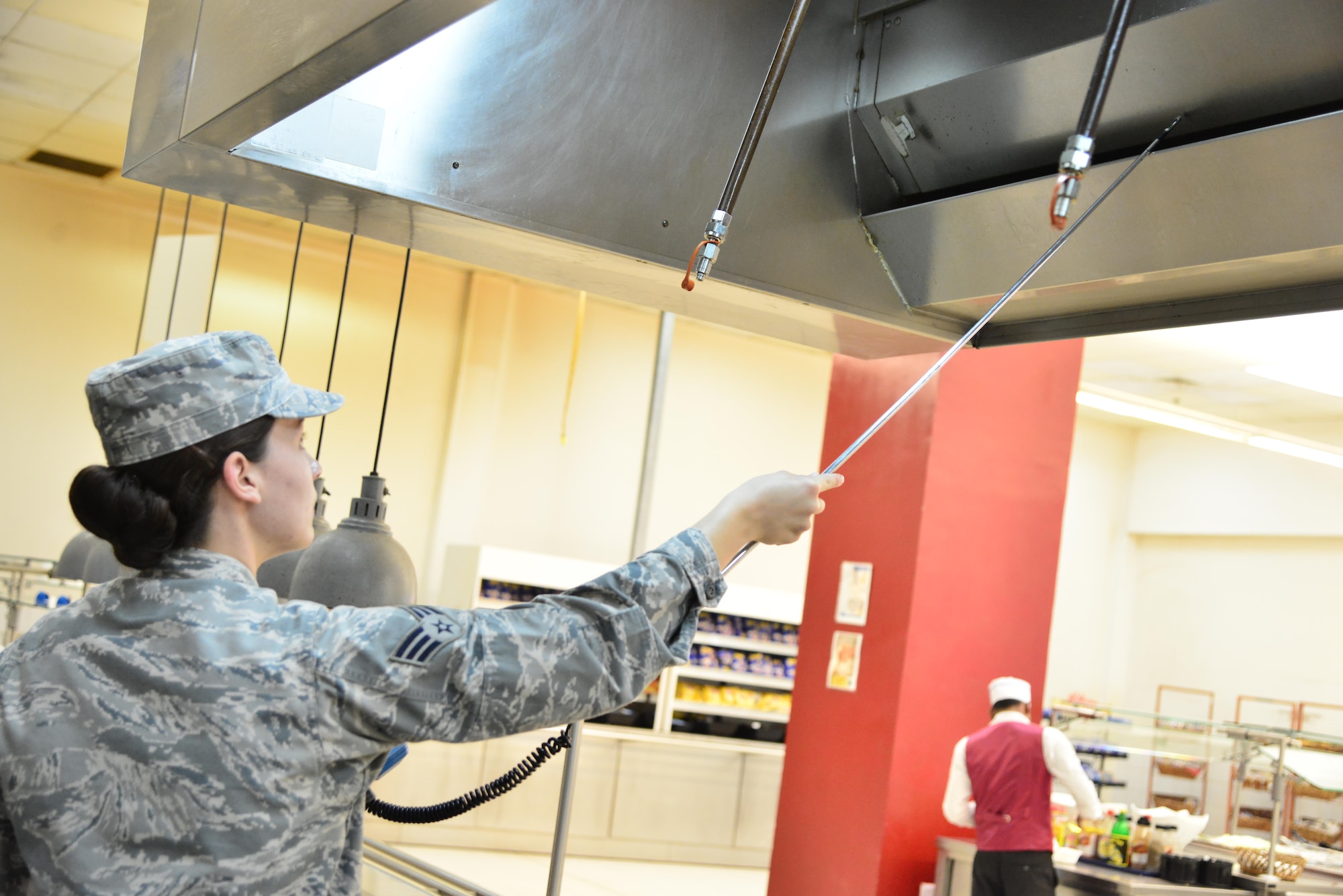 Senior Airman Leah Smith, 379th Expeditionary Medical Operations Support Squadron Bioenvironmental, uses a Direct-Reading instrument to measure the flow rate of air that is being passed through the dining facility ventilation system September 30, 2015 at Al Udeid Air Base, Qatar. (U.S. Air Force photo/Staff Sgt. Alexandre Montes)