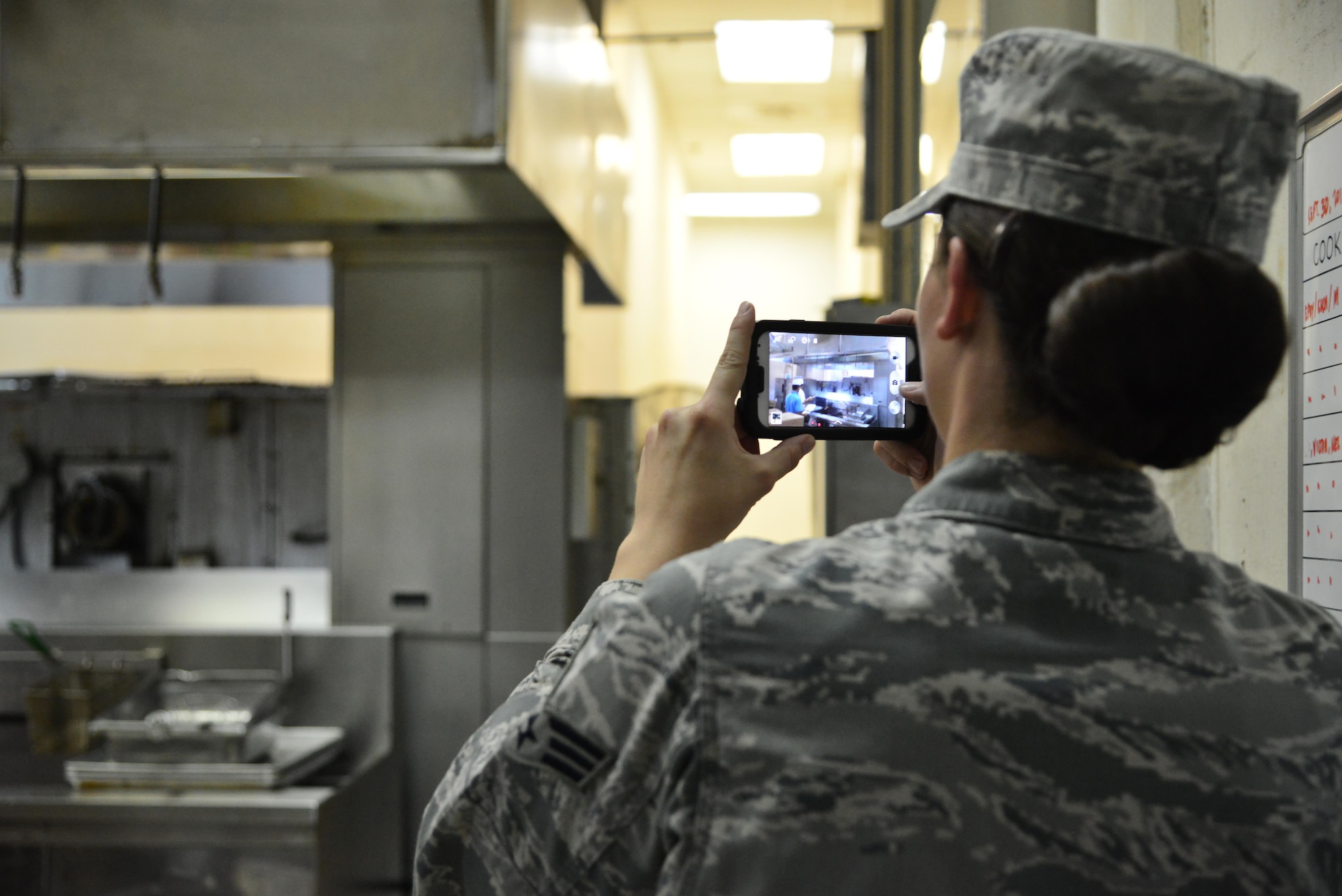 Senior Airman Leah Smith, 379th Expeditionary Medical Operations Support Squadron Bioenvironmental, captures photographic logs of a dining facility ventilation system being tested for air flow to meet Occupational Safety and Health Administration standards September 30, 2015 at Al Udeid Air Base, Qatar. (U.S. Air Force photo/Staff Sgt. Alexandre Montes)  