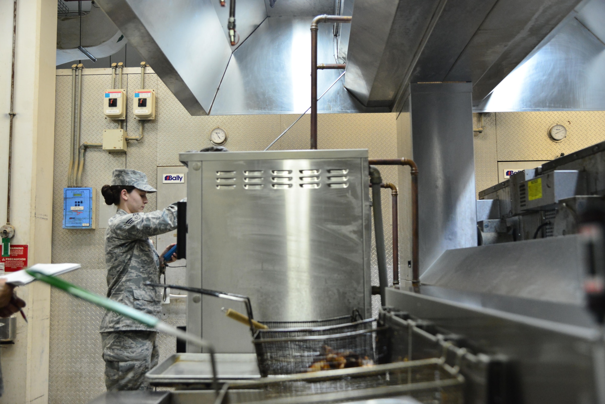 Senior Airman Leah Smith, 379th Expeditionary Medical Operations Support Squadron Bioenvironmental, uses a Direct-Reading instrument to measure the flow rate of air that is being passed through the dining facility ventilation system September 30, 2015 at Al Udeid Air Base, Qatar. (U.S. Air Force photo/Staff Sgt. Alexandre Montes)