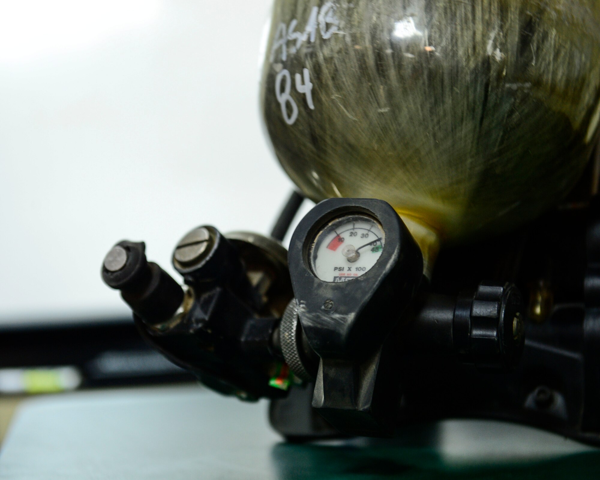 Firefighters of the 386th Civil Engineer Squadron fire department use a high-pressured tank during a safety brief in preparation for Fire Prevention Week at an undisclosed location in Southwest Asia, Sept. 30, 2015. Firefighters support Operation Inherent Resolve with education in alarm center operations; care, use and servicing of portable fire extinguishers; preventive and operator maintenance on firefighting apparatus and equipment; and the principles of fire inspections and investigations. (U.S. Air Force photo by Senior Airman Racheal E. Watson/Released)
