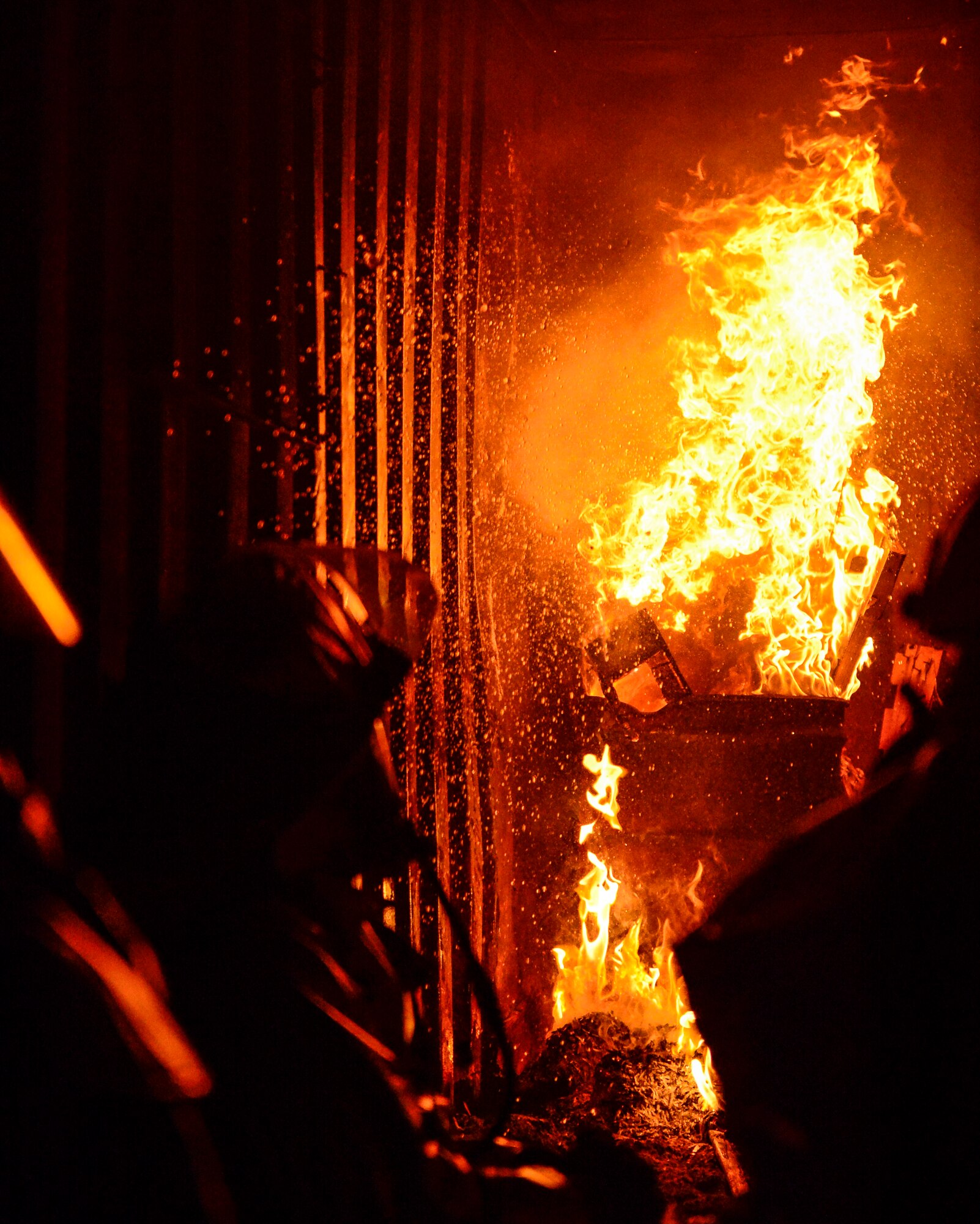 Firefighters of the 386th Civil Engineer Squadron fire department conduct a controlled burn demonstration for members of the 386th Force Protection Squadron in preparation for Fire Prevention Week at an undisclosed location in Southwest Asia, Sept. 30, 2015. The fire training facility provides realistic training with controlled flames emanating from specific areas of the building to increase readiness of base firefighters. (U.S. Air Force photo by Senior Airman Racheal E. Watson/Released)
