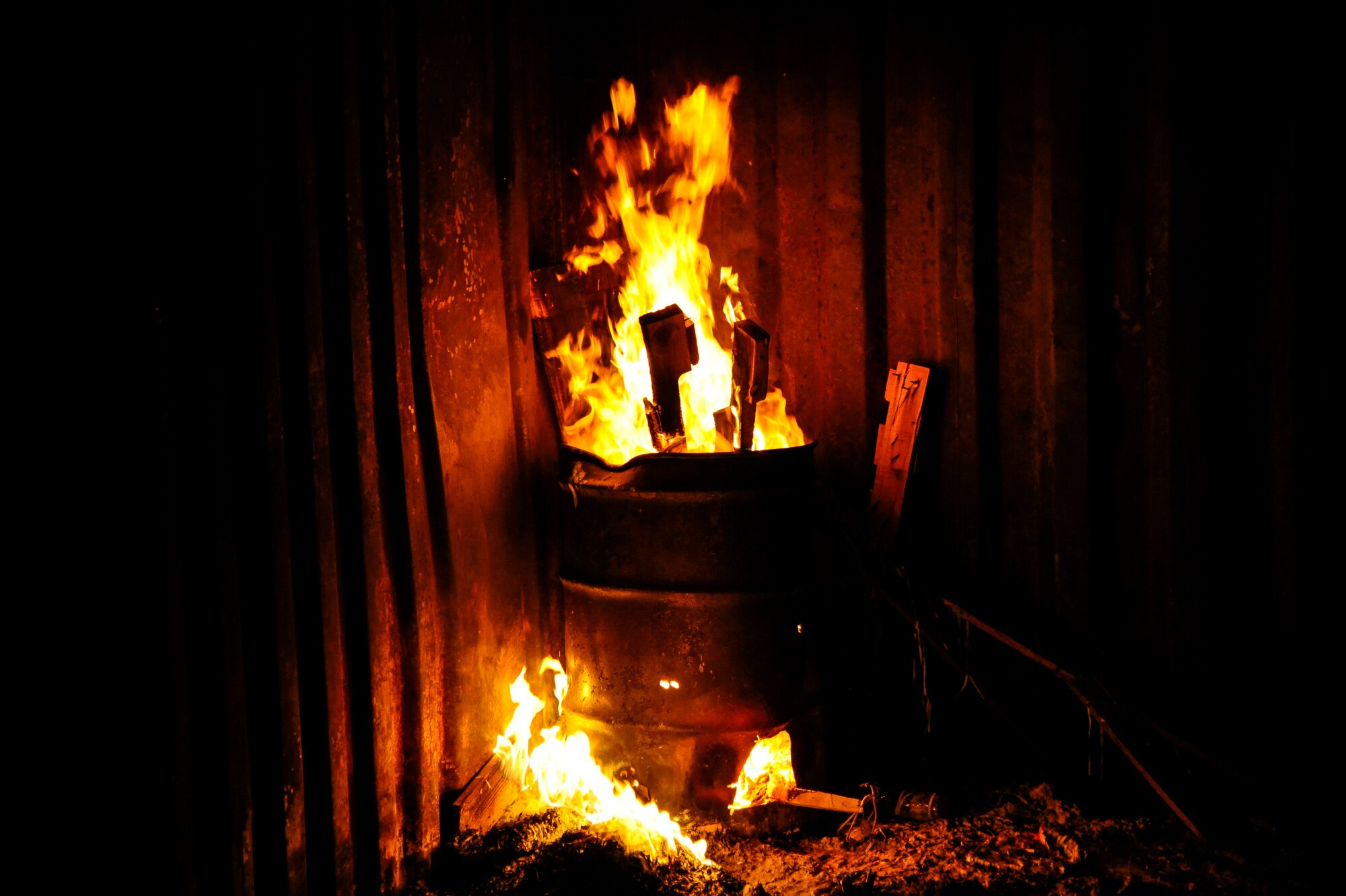 A barrel filled with debris burns  at an undisclosed location in Southwest Asia, 30 Sep, 2015. Members of the 386th Expeditionary Force Protection Squadron participated in controlled burn training offered by the 386th Expeditionary Civil Engineer Squadron fire department in preparation for Fire Prevention Week. (U.S. Air Force photo by Chief Master Sgt. Richard Vargas/Released) 