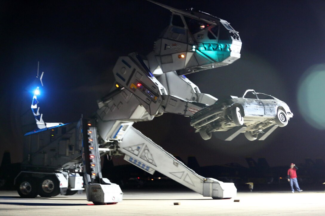 Robosaurus begins to crush a vehicle during its performance at the 2015 MCAS Miramar Air Show aboard Marine Corps Air Station Miramar, California, Oct. 3. Robosaurus transforms from a semi-truck to a 30-ton, 40-foot tall metal T-Rex. (U.S. Marine Corps photo by Sgt. Melissa Wenger/Released)