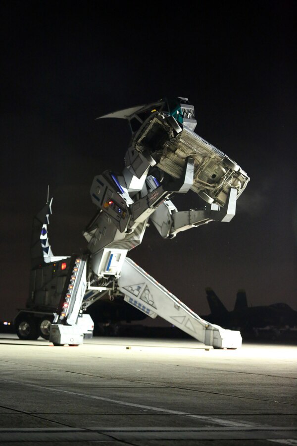 Robosaurus begins to consume a vehicle during its performance at the 2015 MCAS Miramar Air Show aboard Marine Corps Air Station Miramar, California, Oct. 3. Robosaurus transforms from a semi-truck to a 30-ton, 40-foot tall metal T-Rex. (U.S. Marine Corps photo by Sgt. Melissa Wenger/Released)