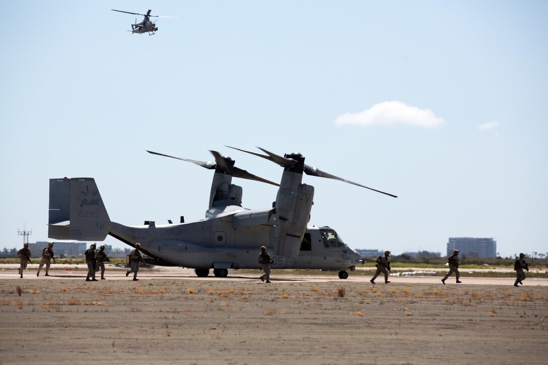 Marines with 1st Marine Division exit an MV-22B Osprey during the Marine Air-Ground Task Force demonstration as part of the 2015 MCAS Miramar Air Show aboard Marine Corps Air Station Miramar, Calif., Oct. 2. The MAGTF demonstration showed the unique relationship between air support and ground troops during various types of operations. (U.S. Marine Corps photo by Sgt. Michele Hunt/Released)
