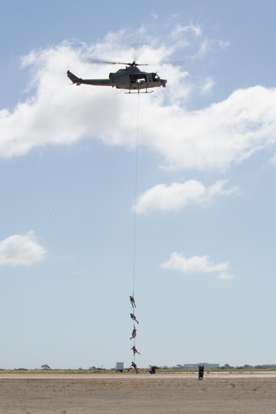 A UH-1Y Huey lifts Marines over the flight line at Marine Corps Air Station Miramar, Calif., as part of the Marine Air-Ground Task Force demonstration during the 2015 MCAS Miramar Air Show Oct. 2. This is a form of special patrol insertion or extraction the Marine Corps uses in real-world scenarios. (U.S. Marine Corps photo by Sgt. Michele Hunt/Released)