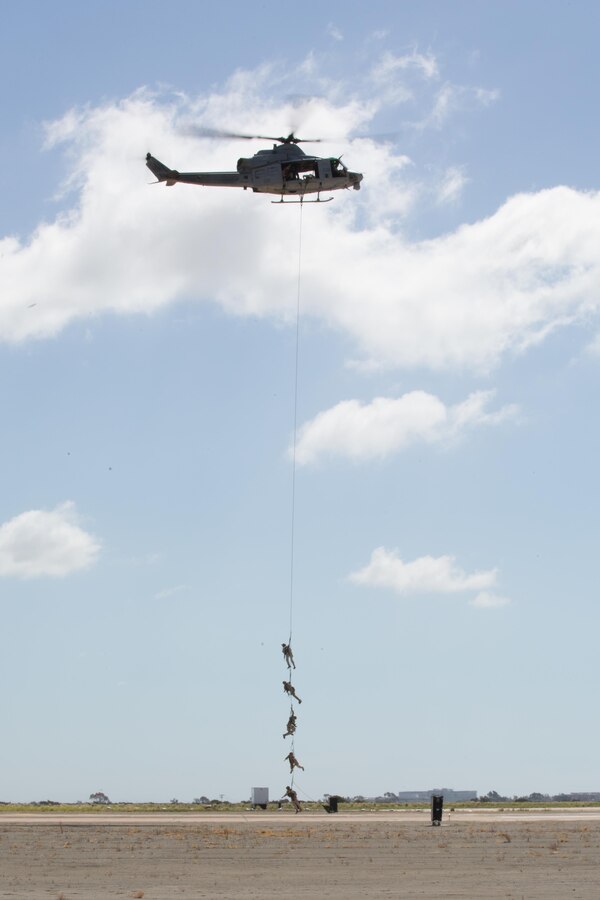 A UH-1Y Huey lifts Marines over the flight line at Marine Corps Air Station Miramar, Calif., as part of the Marine Air-Ground Task Force demonstration during the 2015 MCAS Miramar Air Show Oct. 2. This is a form of special patrol insertion or extraction the Marine Corps uses in real-world scenarios. (U.S. Marine Corps photo by Sgt. Michele Hunt/Released)