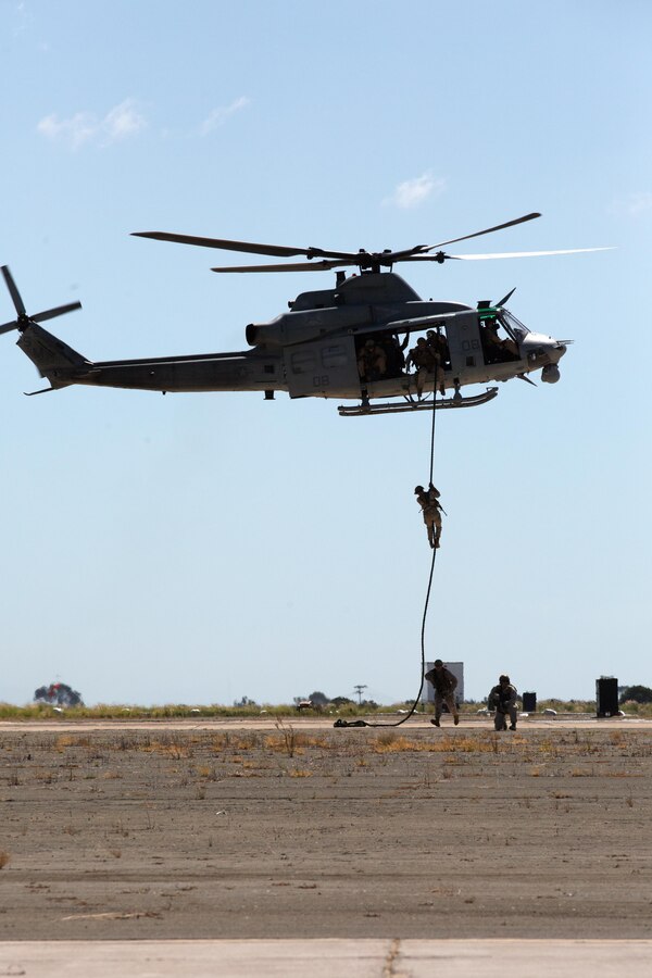 Marines with 1st Marine Division fast rope out of a UH-1Y Huey while demonstrating Marine Air Ground Task Force operations during the 2015 MCAS Miramar Air Show aboard Marine Corps Air Station Miramar, Calif., Oct. 2. This year's air show honored veterans and their families. (U.S. Marine Corps photo by Sgt. Michele Hunt/Released)
