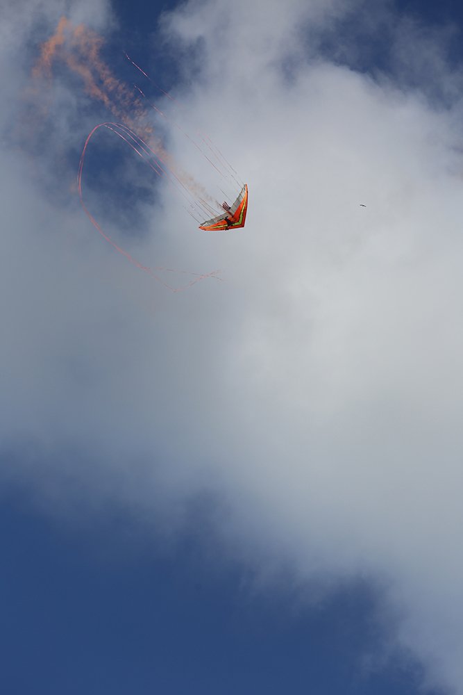 Dan Buchanan’s power glider paints the sky with colored smoke on the flight line 2015 MCAS Air Show aboard Marine Corps Air Station Miramar, California, Oct. 2. Buchanan uses special effects to illuminate and emit colored smoke from his power glider. (U.S. Marine Corps photo by Sgt. Melissa Wenger/Released)