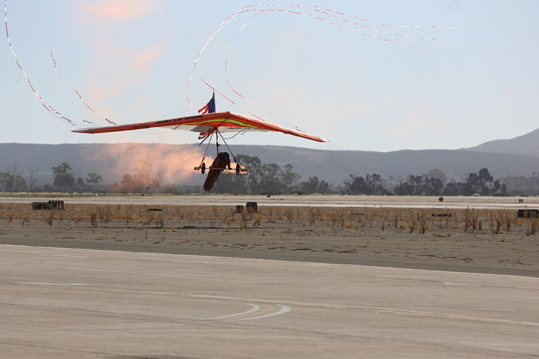 Dan Buchanan, a featured performer of the 2015 MCAS Miramar Air Show, prepares to land his hang glider aboard Marine Corps Air Station Miramar, Calif., Oct. 2. Buchanan uses a powerless hang glider and a motorized wing during his performances. (U.S. Marine Corps photo by Sgt. Melissa Wenger/Released)