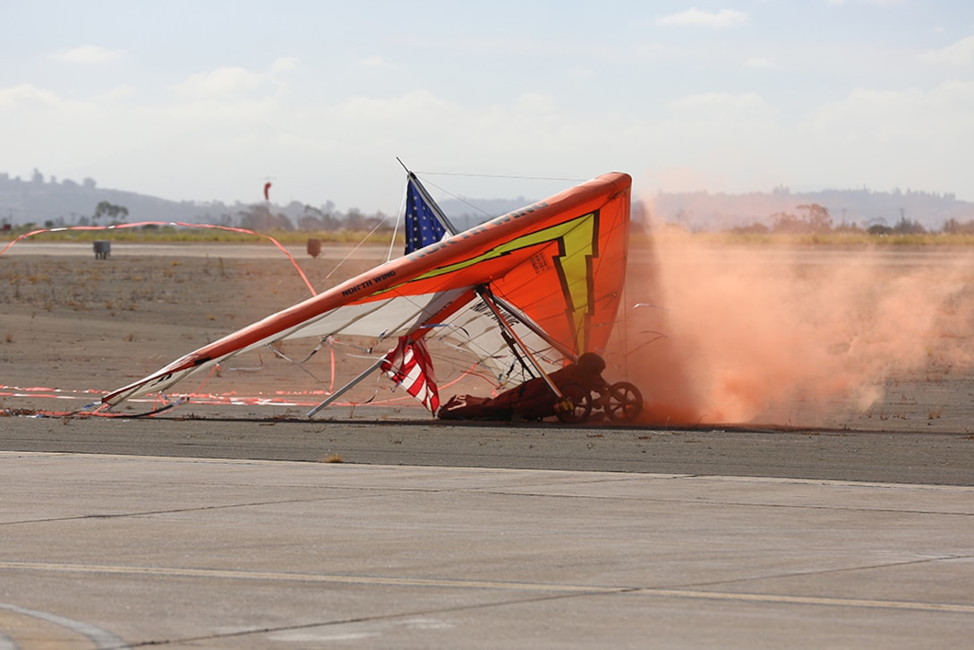Dan Buchanan lands his hang glider on the flightline 2015 MCAS Miramar Air Show aboard Marine Corps Air Station Miramar, Calif., Oct. 2. Buchanan uses special effects to illuminate and emit colored smoke from his power glider. (U.S. Marine Corps photo by Sgt. Melissa Wenger/Released)