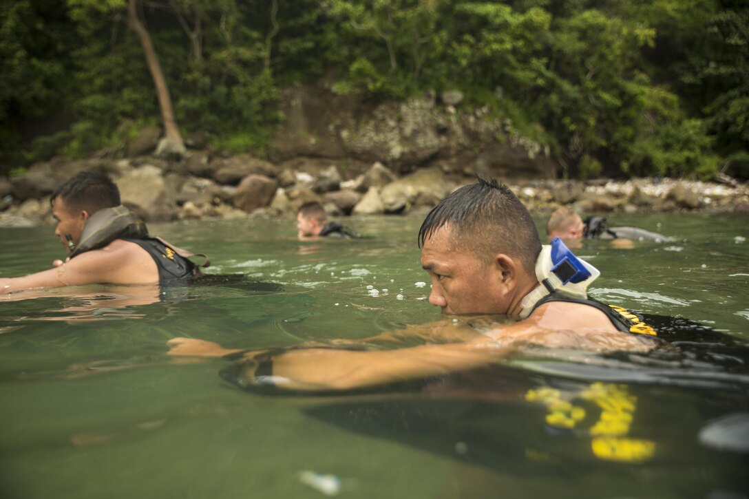 Philippine Marine Corps Cpl. Randy Bolanio performs scout swimmer techniques with U.S. Reconnaissance Marines at Ternate, Philippines, Oct. 1, 2015, during Amphibious Landing Exercise 2015. The Marines rehearsed clandestine landings with their Filipino counterparts, which increased their mission readiness. PHIBLEX 2015 is an annual, bilateral training exercise conducted by U.S. Marine and Navy Forces with the Armed Forces of the Philippines in order to strengthen our interoperability and working relationships across the range of military operations — from disaster relief, to complex expeditionary operations. Bolanio is a reconnaissance man with 64th Force Reconnaissance Company, Marine Special Operations Group. The U.S. Marines are reconnaissance men with 3rd Reconnaissance Battalion, 3rd Marine Division, III Marine Expeditionary Force.