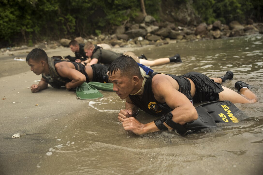 Philippine Marine Corps Cpl. Randy Bolanio executes a clandestine landing with U.S. Reconnaissance Marines at Ternate, Philippines, Oct. 1, 2015, during Amphibious Landing Exercise 2015. The Marines rehearsed clandestine landings with their Filipino counterparts, which increased their mission readiness during maritime raid operations. PHIBLEX 2015 is an annual, bilateral training exercise conducted by U.S. Marine and Navy Forces with the Armed Forces of the Philippines in order to strengthen our interoperability and working relationships across the range of military operations — from disaster relief, to complex expeditionary operations. Bolanio is a reconnaissance man with 64th Force Reconnaissance Company, Marine Special Operations Group.  The U.S. Marines are reconnaissance men with 3rd Reconnaissance Battalion, 3rd Marine Division, III Marine Expeditionary Force.
