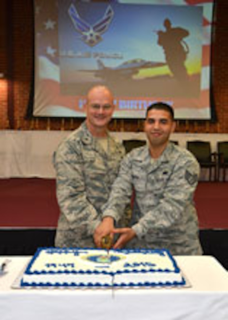In celebration of the 68th Air Force Birthday, DLA Aviation Commander Brig. Gen. Allan Day and the most junior DLA Aviation Airman in attendance, Staff Sgt Jimmy Pauth, inventory management specialist, Customer Operations Directorate, cut the Air Force birthday cake during a celebration September 21, 2015 at Defense Supply Center Richmond, Virginia.  