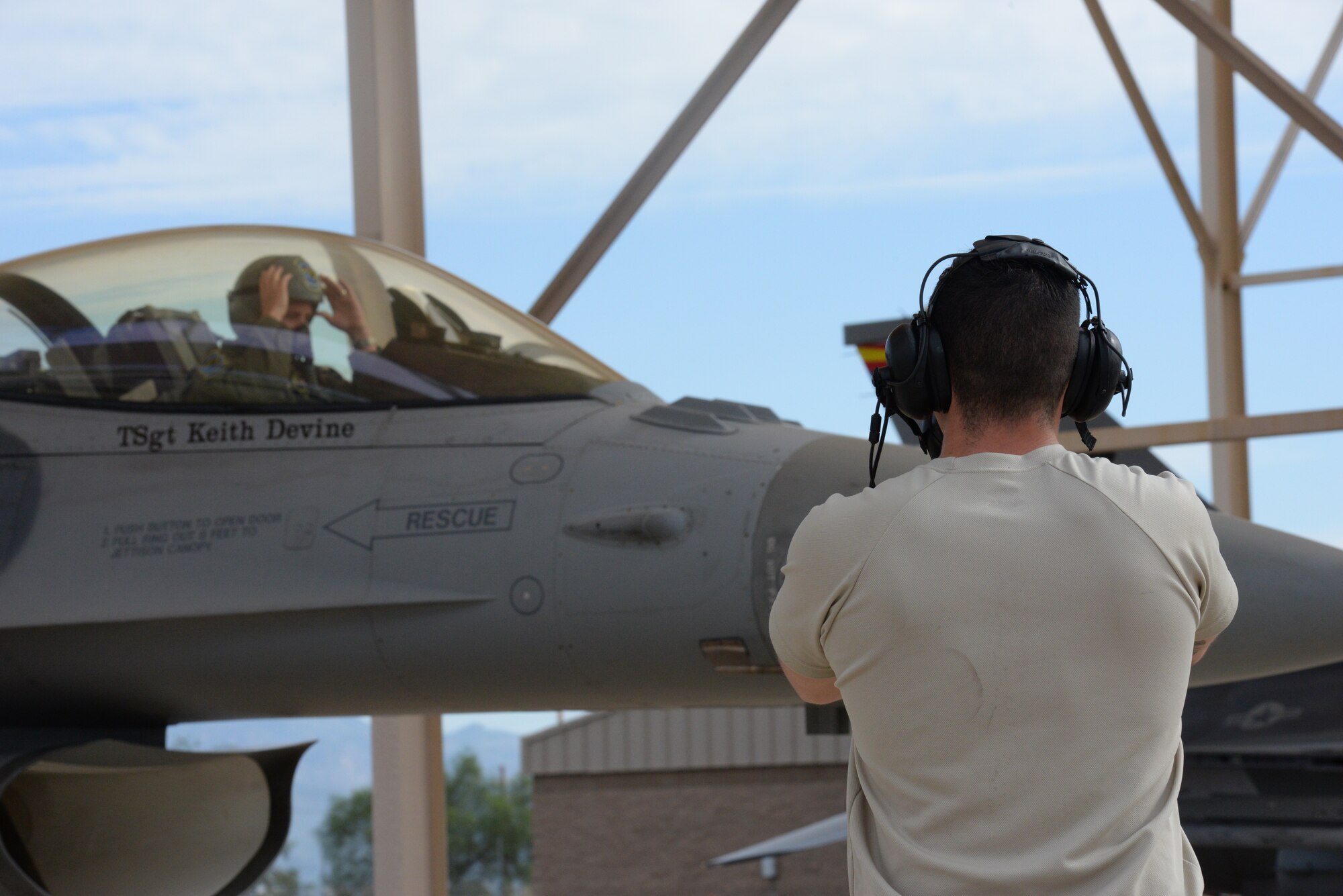 A crew chief ensures an F-16 pilot from the Aerospace Control Alert Detachment from the 162nd Wing is prepared for take-off Sept. 12, 2015, at Davis-Monthan Air Force Base. It is the responsibility of a crew chief from the Aerospace Control Alert Detachment to perform the final checks before a pilot takes flight. The detachment maintains the ability to quickly scramble in response to airborne threats in the Southwest United States, as well as proactively defend large gatherings and high profile events. (Air National Guard photo by Senior Airman Jackson Hurd)