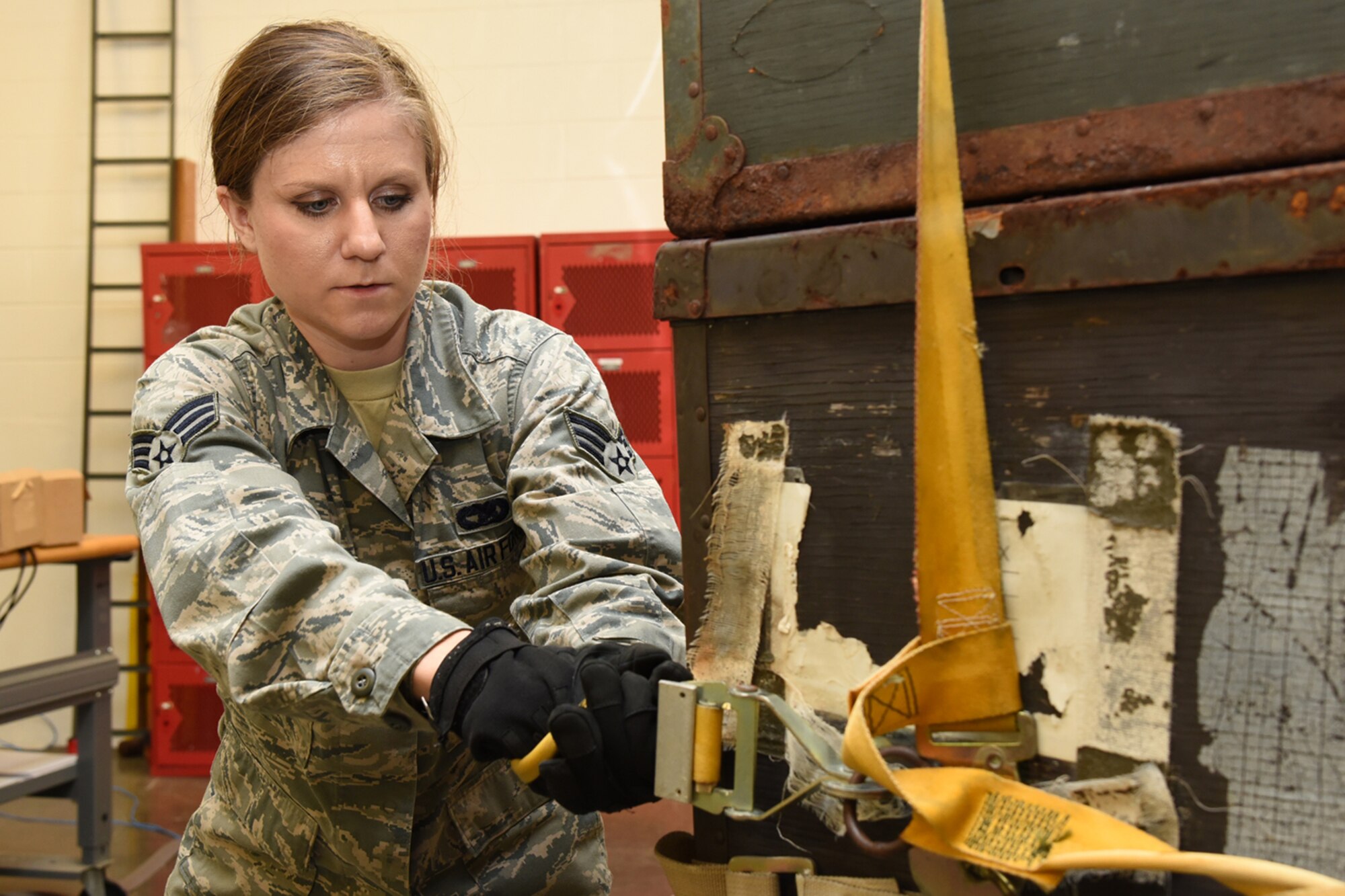 Senior Airman Lindsey Caldwell, 403rd Aerial Port Squadron aircraft transportation specialist, straps cargo to a pallet during the pallet buildup competition of the “Port Dawg” Challenge Oct. 3, 2015, at Keesler Air Force Base, Mississippi. The competition is designed to develop healthy competitiveness and esprit de corps while working on building a more proficient aerial port squadron. (U.S. Air Force photo/Tech. Sgt. Ryan Labadens)