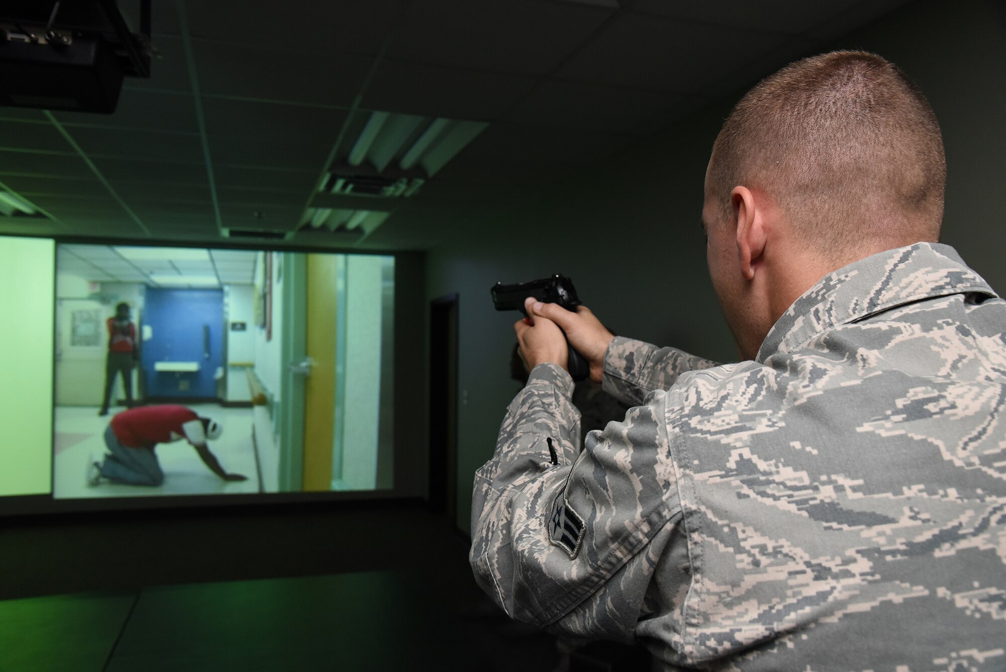 Senior Airman Sebastian Green, 403rd Security Forces Squadron fire team member, trains on the latest version of the Firearms Training System at Keesler Air Force Base, Mississippi, Oct. 4, 2015. The system provides multiple, realistic scenarios for which security forces members can receive instant feedback based on their training performance. (U.S. Air Force photo/Tech. Sgt. Ryan Labadens)