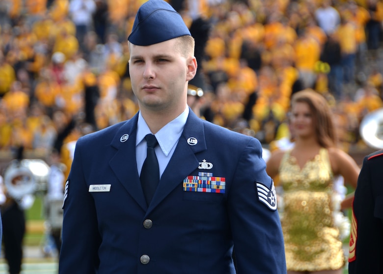 Staff Sgt. Daniel Middleton, a tactical data link coordinator with the 131st Bomb Wing takes his place on the field during a ceremony to honor military members in Columbia, Missouri, Oct. 3, 2015.  Middleton was one out of 10 military members from around the state that were chosen as this year’s Adopt A Warrior honorees.  Middleton was also awarded the Master Sergeant Lee A. Messina Trophy for Outstanding Enlisted Achievement, as well as the U.S. Exercise Tiger Foundation’s Medal of Combat Valor.   (U.S. Air National Guard photo by Tech. Sgt. Traci Howells)