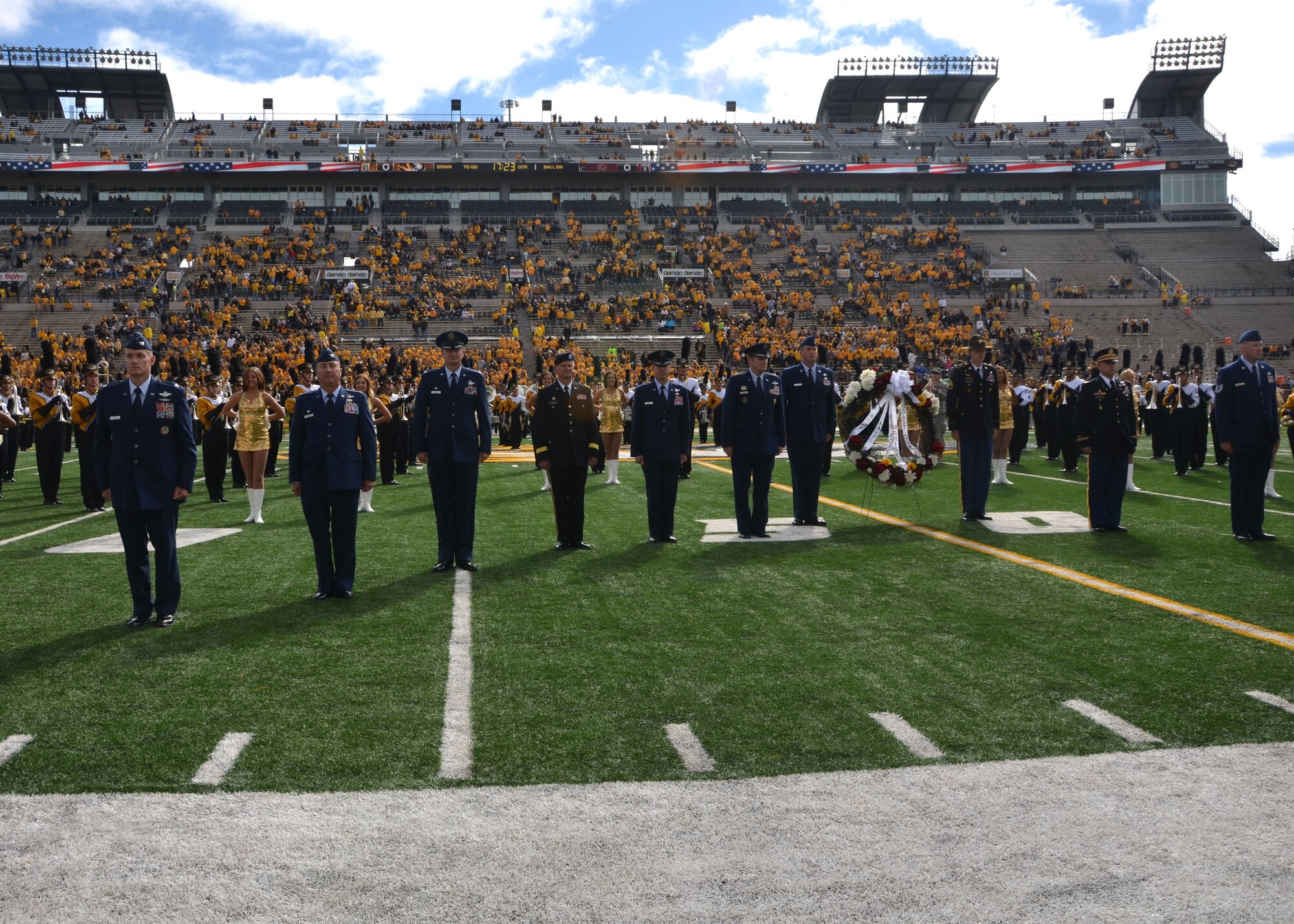 Military leadership and National Adopt A Warrior honorees take their places on the football field for a ceremony at the University of Missouri in Columbia, Oct. 3, 2015.  The servicemen and women were honored prior to the game as part of Military Appreciation Day.  (U.S. Air National Guard photo by Tech. Sgt. Traci Howells)