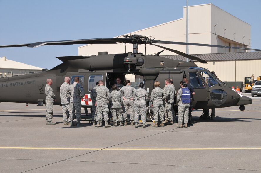Crew chiefs from the Montana Army National Guard’s 1-189th Aviation Battalion instruct Airmen from the 341st and 120th Medical Groups on how to load litters into an H-60 Blackhawk helicopter during a mass casualty exercise Aug. 10, 2015, at Malmstrom Air Force Base, Mont. The exercise tested the units’ abilities to jointly respond to a mass casualty event resulting from a natural disaster. (U.S. Air National Guard photo/ Tech. Sgt. Michael Touchette)