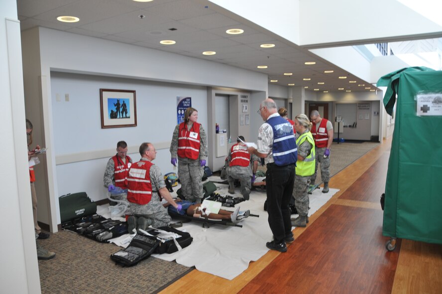 Airmen from the 341st and 120th Medical Groups treat a simulated casualty during a mass casualty exercise Aug. 10, 2015, at Malmstrom Air Force Base, Mont. The training tested the units’ ability to process large numbers of victims following a natural disaster. (U.S. Air National Guard photo/ Tech. Sgt. Michael Touchette)