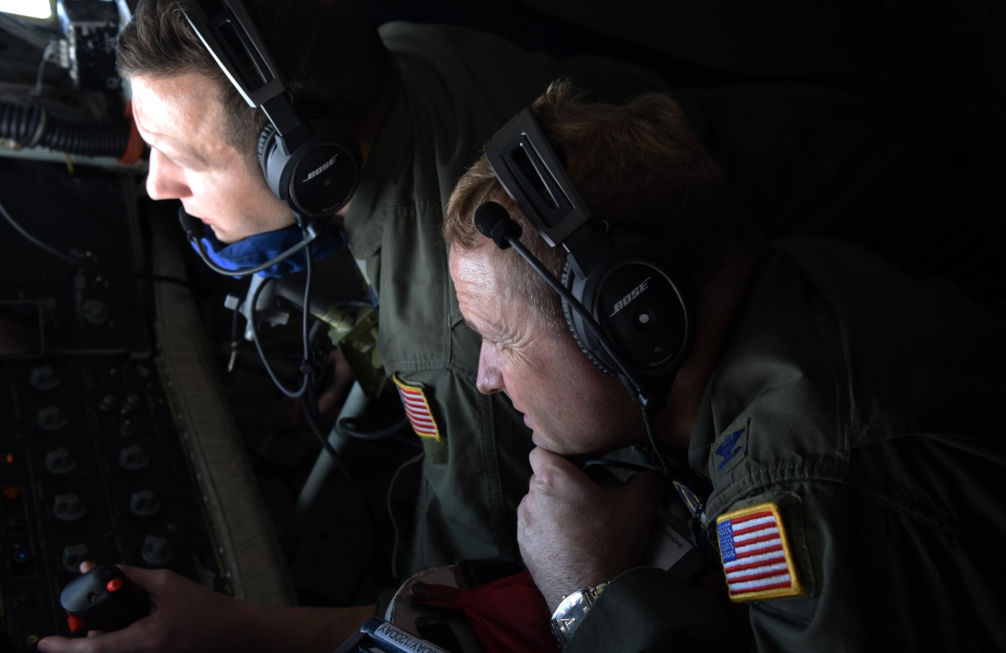 Col. Brad Anderson, watches Tech St. Josh Kirkland, 63rd Air Refueling Squadron, boom operator, perform an in-air refueling with a C-17 Globemaster III during his final flight as the 927th Air Refueling Wing vice commander, Saturday, October 3, 2015. The “fini flight” allow pilots an opportunity to fly one more time with crew members and watch the mission being done. (U.S. Air Force Photo by Staff Sgt. Adam C. Borgman)