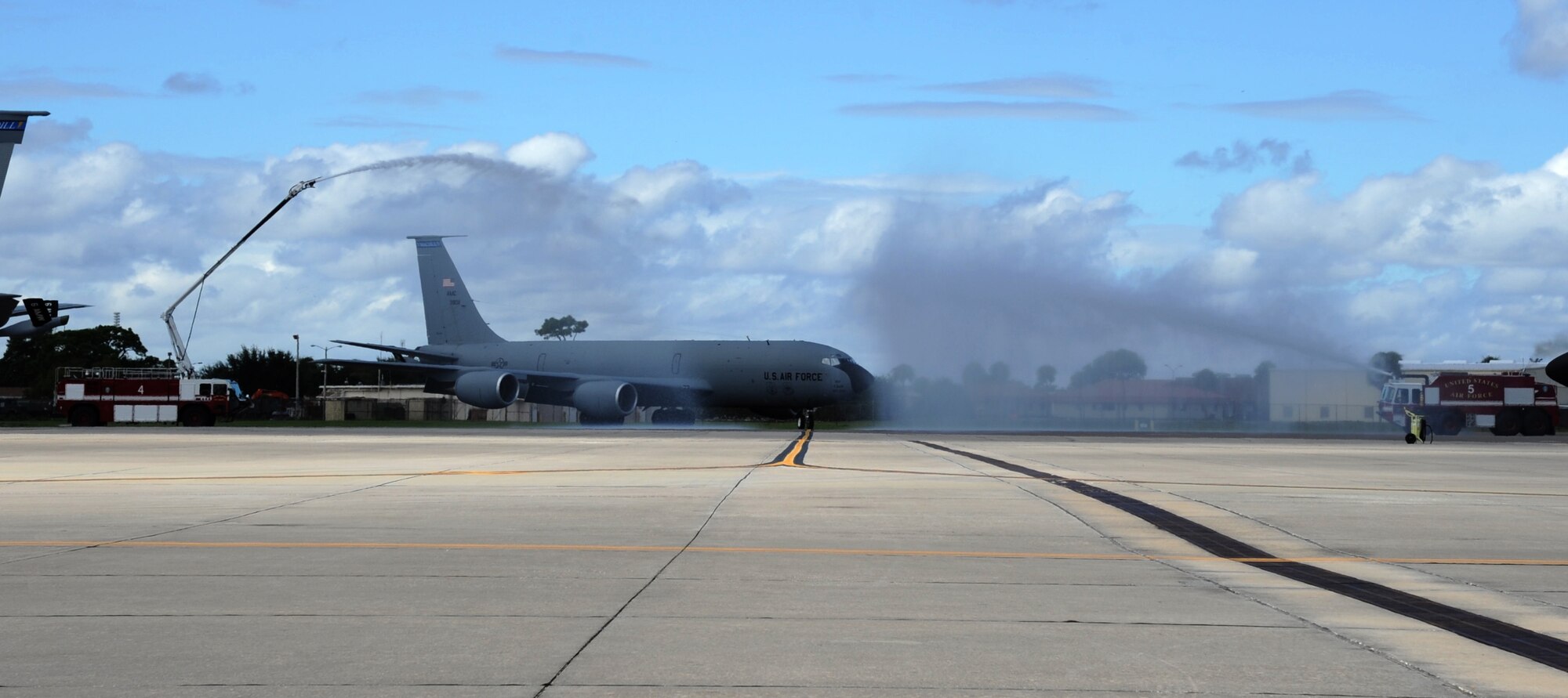 Col. Brad Anderson, took his final flight as the 927th Air Refueling Wing vice commander, Saturday, October 3, 2015. Following a tradition in which aircrew members, upon completion of their final flight with the wing, or "fini flight," are met and hosed down with water by their squadron comrades, family and friends. For Anderson, they drenched the tanker with fire trucks. (U.S. Air Force Photo by Tech. Sgt. Peter Dean)