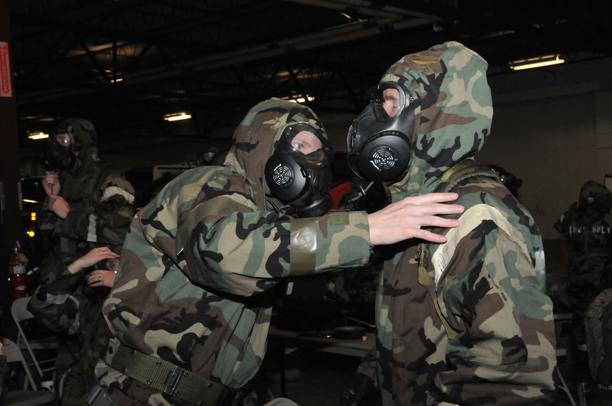 Airman of the Montana National Guard check over the ties and snaps of their chemical warfare gear in the unit’s cold storage building during expeditionary skills rodeo training Feb. 7, 2015. (U.S. Air National Guard photo/Tech. Sgt. Christy Mason) 

