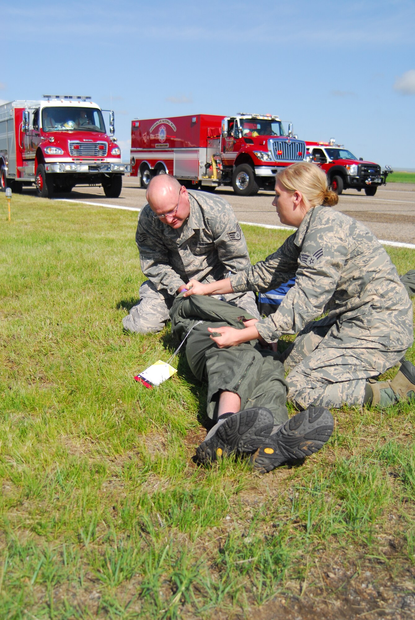 Emergency personnel tend to a simulated casualty during a major accident response exercise conducted June 1, 2014, at the 120th Airlift Wing in Great Falls, Mont. (U.S. Air National Guard photo/1st Lt. Robin Allen)
