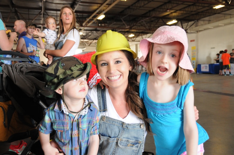 Montana Air National Guard Airman and Family Readiness Program Manager Paige Held poses with two happy family members during the 2015 MTANG Family Day event June 6, held at the base in Great Falls, Mont. (U.S. Air National Guard photo/Senior Airman Nikolas Asmussen)
