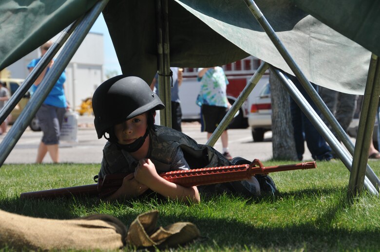 A young family member low crawls through an obstacle course during a Family Day event June 6, 2015, at the Montana Air National Guard in Great Falls, Mont. (U.S. Air National Guard photo/Senior Airman Nikolas Asmussen)
