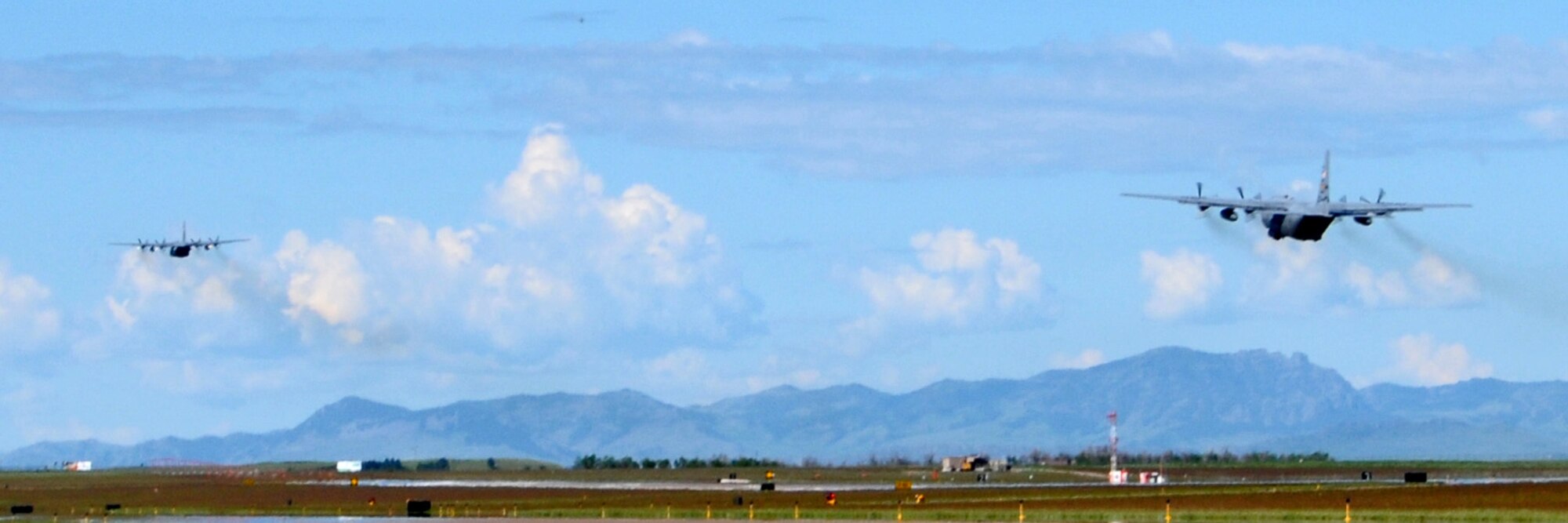 A two ship of C-130 Hercules from the 120th Airlift Wing take off June 6, 2015, from the Montana Air National Guard  base in Great Falls, Mont., in support of a boss-lift. Forty-seven bosses spent the morning learning about what the guard and reserve do during unit training assemblies. (U.S. Air National Guard photo/Staff Sgt Lindsey Soulsby)