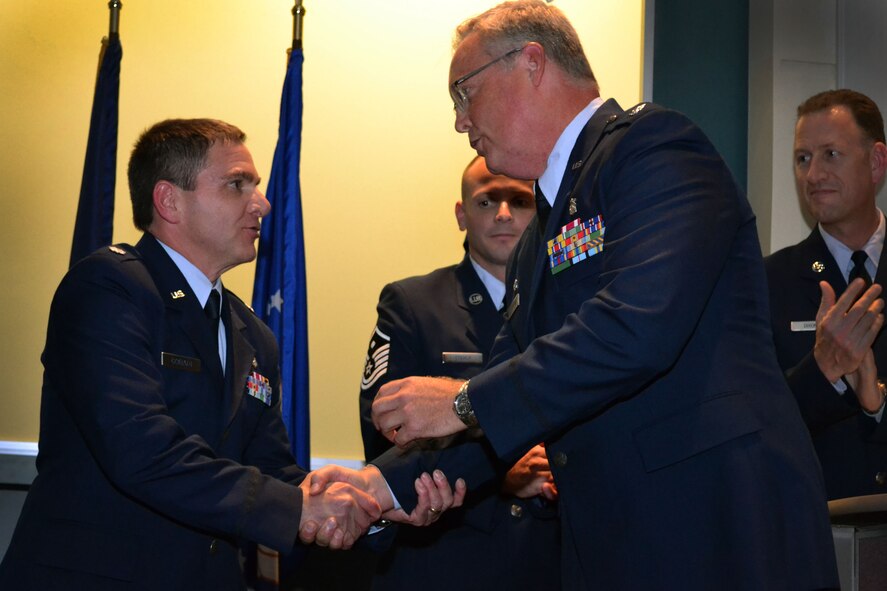 Newly-appointed 111th Medical Group Commander Lt. Col. Scott Coradi is congratulated by the outgoing medical group commander, Lt. Col. John P. Quinn Jr., during a change of command ceremony Oct. 3, 2015, Horsham Air Guard Station, Pennsylvania. Coradi began his military career as an enlisted firefighter. (U.S. Air National Guard photo by Tech. Sgt. Andria Allmond/Released)