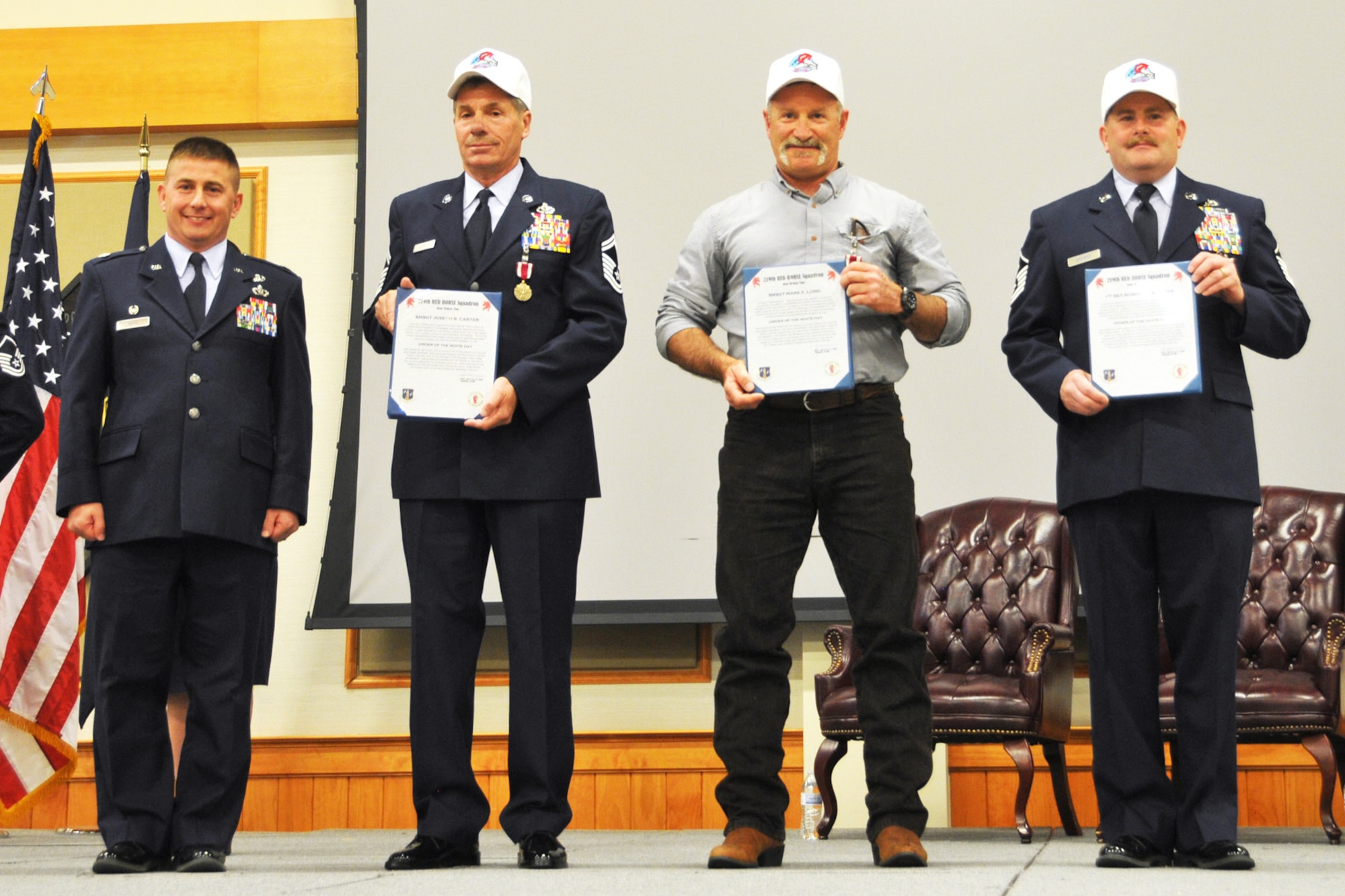 219th RED HORSE Commander Lt. Col. Rusty Vaira, left, presented Order of the White Hat certificates and hats to Senior Master Sgt. Joseph Carter, Senior Master Sgt. Mark Lund and Master Sgt. Robert Brewer  during their retirement ceremonies May 2, 2015. (U.S. Air National Guard photo/1st Lt. Robin Allen)

