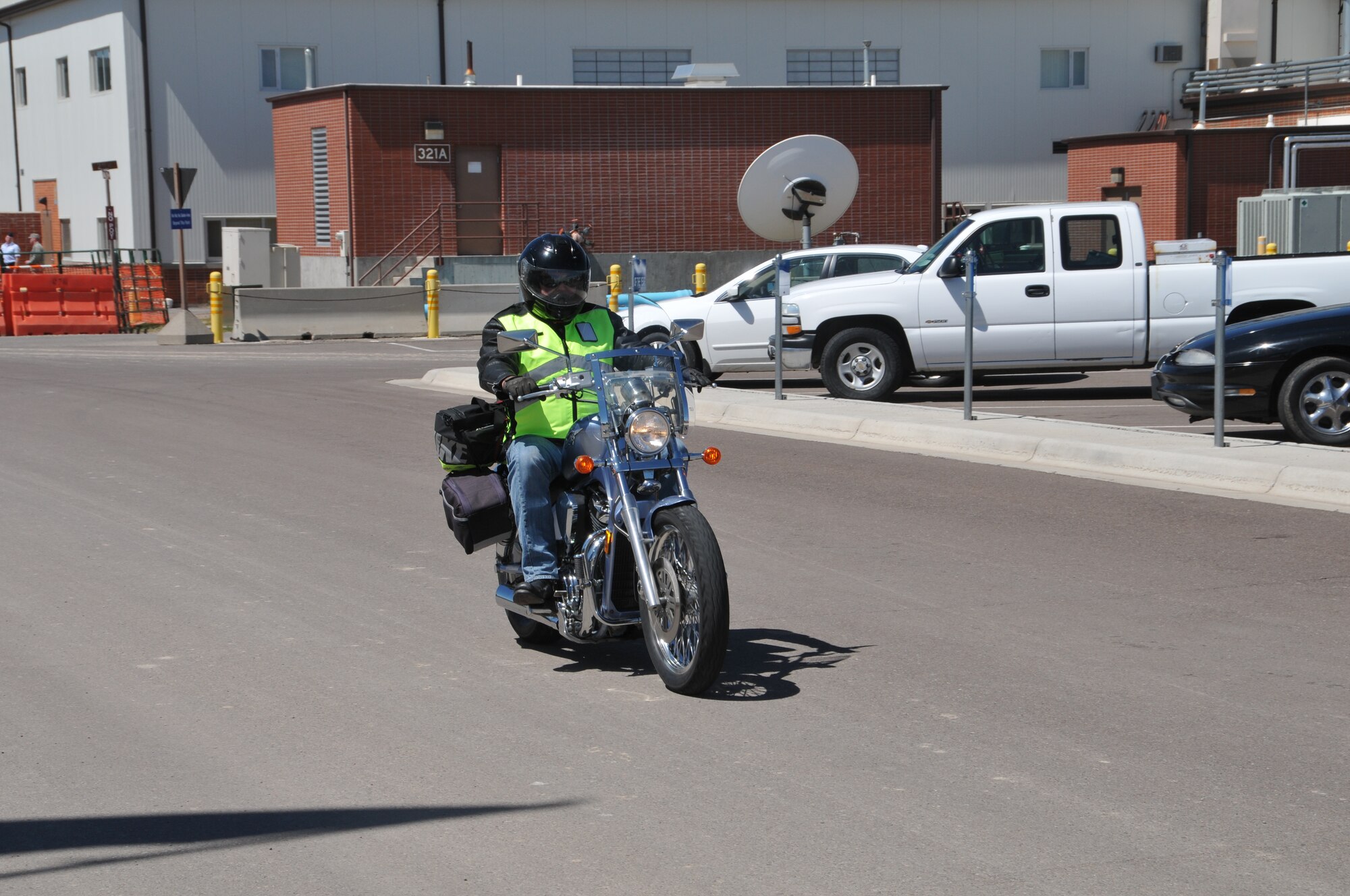 120th Airlift Wing Master Sgt. Winston Wilbur demonstrates the correct use of personal protective equipment as he rides his motorcycle home from work May 21, 2015, at Great Falls, Mont. (U.S. Air National Guard photo/Senior Master Sgt. Eric Peterson)