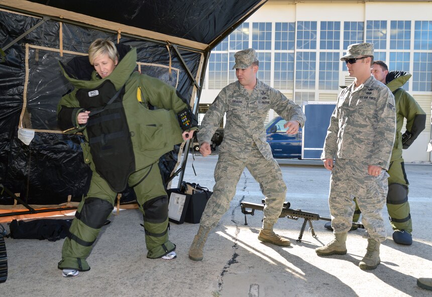 Tech. Sgt. Cody Cochran of the 433rd Civil Engineer Squadron explosive ordnance disposal flight shows Kelly Lerch, Enterprise Holdings of South Texas group talent acquisition manager, how to remove the top of a bomb disposal as part of an EOD demonstration for 433rd Airlift Wing Honorary Commanders Oct. 3, 2015 at Joint Base San Antonio-Lackland. The demonstration was part of the civic leaders’ 433rd Mission Support Group tour. (U.S. Air Force photo/Tech. Sgt. Lindsey Maurice)