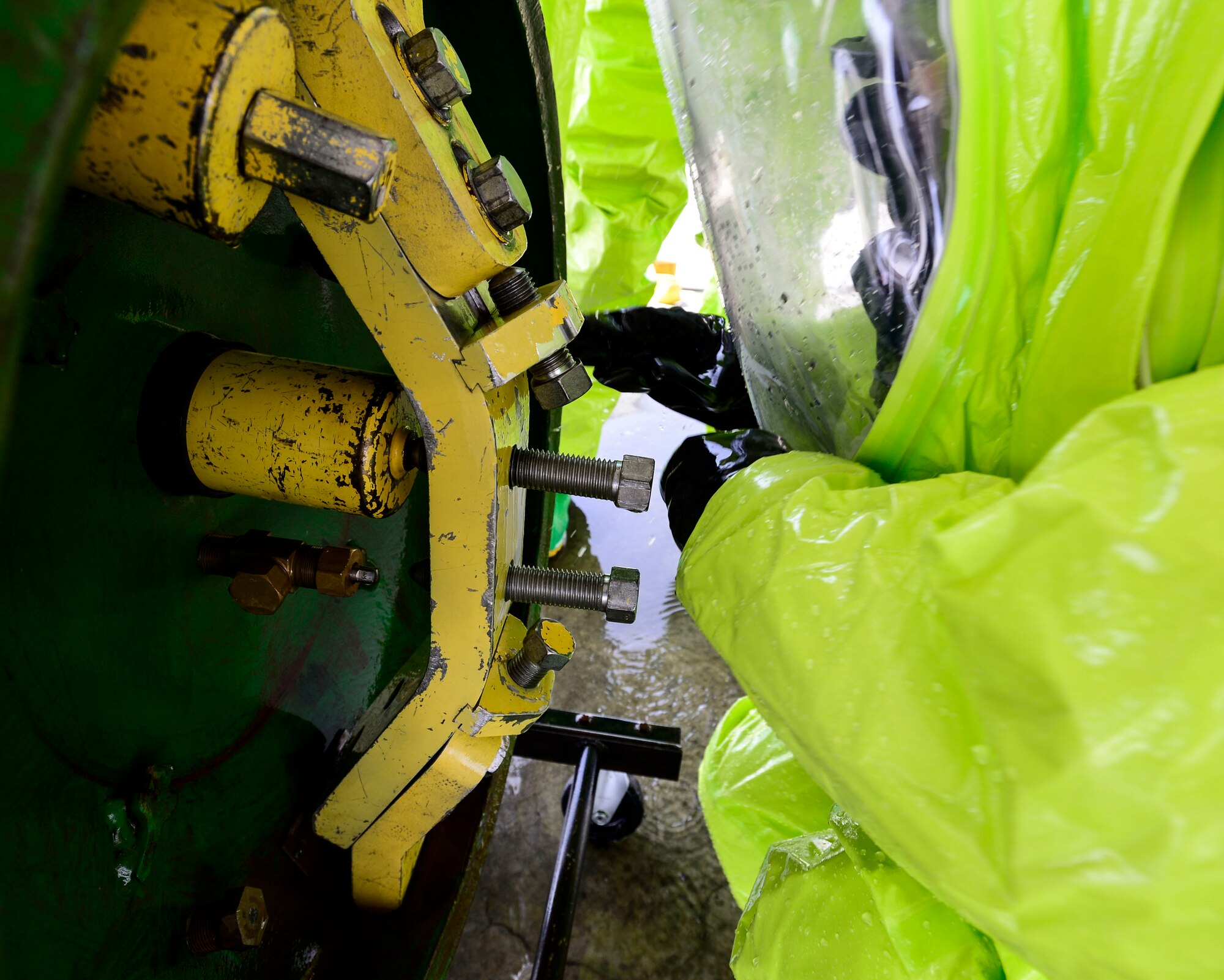 A member of the 386th Civil Engineer Squadron fire department tightens the last bolt during hazardous material certification training at an undisclosed location in Southwest Asia, Sept. 26, 2015. A HAZMAT team responds as a resource to identify and mitigate potential dangerous materials. (U.S. Air Force photo by Senior Airman Racheal E. Watson/Released) 