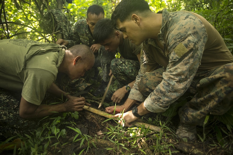 Philippine and U.S. Marines work together to start a fire using bamboo during jungle survival training at Ternate, Philippines, Sept. 29, as part of Amphibious Landing Exercise 2015. The Marines learned basic jungle survival skills, such as building a fire, finding sources of fresh water and catching food. Phiblex 2015 is an annual, bilateral training exercise conducted by U.S. Marine and Navy Forces with the Armed Forces of the Philippines in order to strengthen our interoperability and working relationships across a wide range of military operations — from disaster relief to complex expeditionary operations.