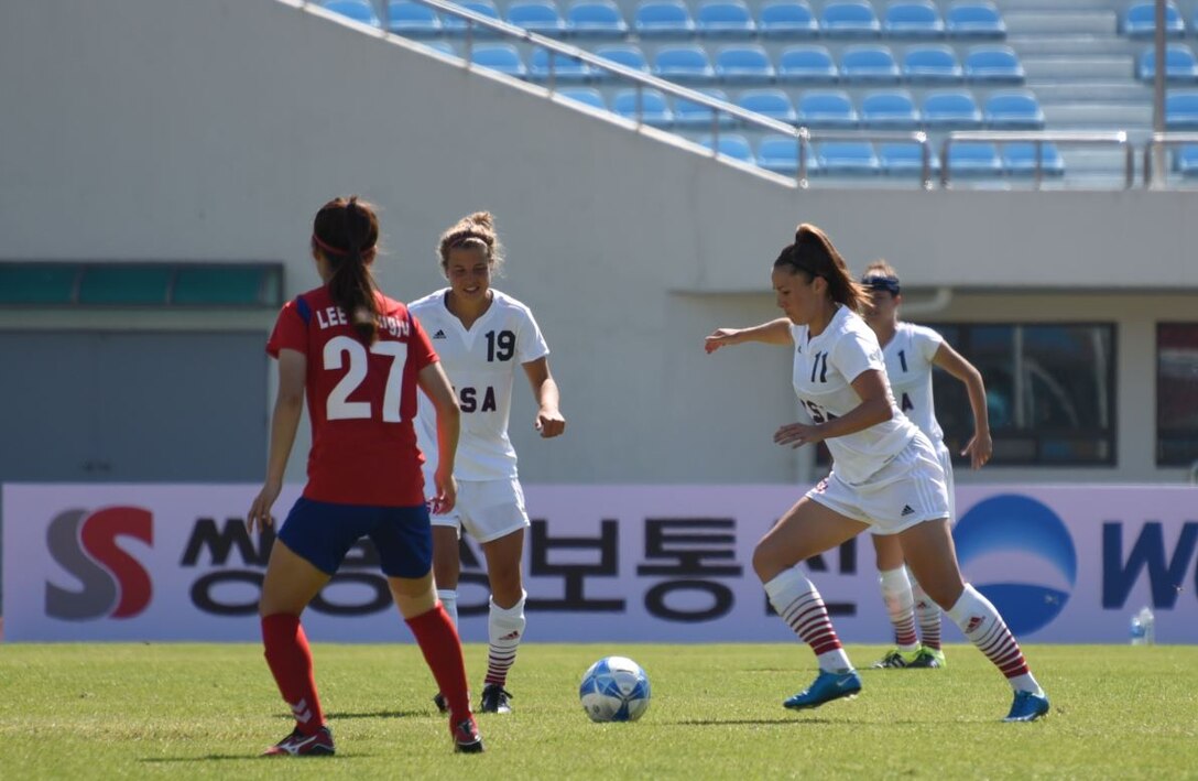 #19 Leah M. Bratt #1 Michelle L. Moeller #11 USA Soccer team member Jennifer M. Grijalva, No. 11, moves forward with the ball during the game against South Korea in Gimcheon, Oct. 5. Teammates Leah Bratt (19) and Michelle Muller (1) follow while Lee, Young Ju (27) of the ROK team marks the play.  