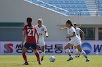 #19 Leah M. Bratt #1 Michelle L. Moeller #11 USA Soccer team member Jennifer M. Grijalva, No. 11, moves forward with the ball during the game against South Korea in Gimcheon, Oct. 5. Teammates Leah Bratt (19) and Michelle Muller (1) follow while Lee, Young Ju (27) of the ROK team marks the play.  
