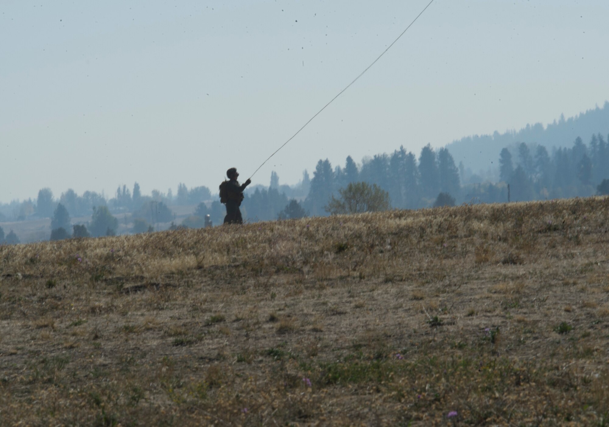 A medic assigned to the 336th Training Support Squadron holds a guideline during a hoist demonstration Sept. 29, 2015, at Fairchild Air Force Base, Wash. Demonstrations were held for Lt. Gen. Darryl Roberson, Air Education and Training Command commander, and AETC civic leaders showing the importance of the Survival, Evasion, Resistance and Escape career field and support units. (U.S. Air Force photo/Airman 1st Class Nick J. Daniello)