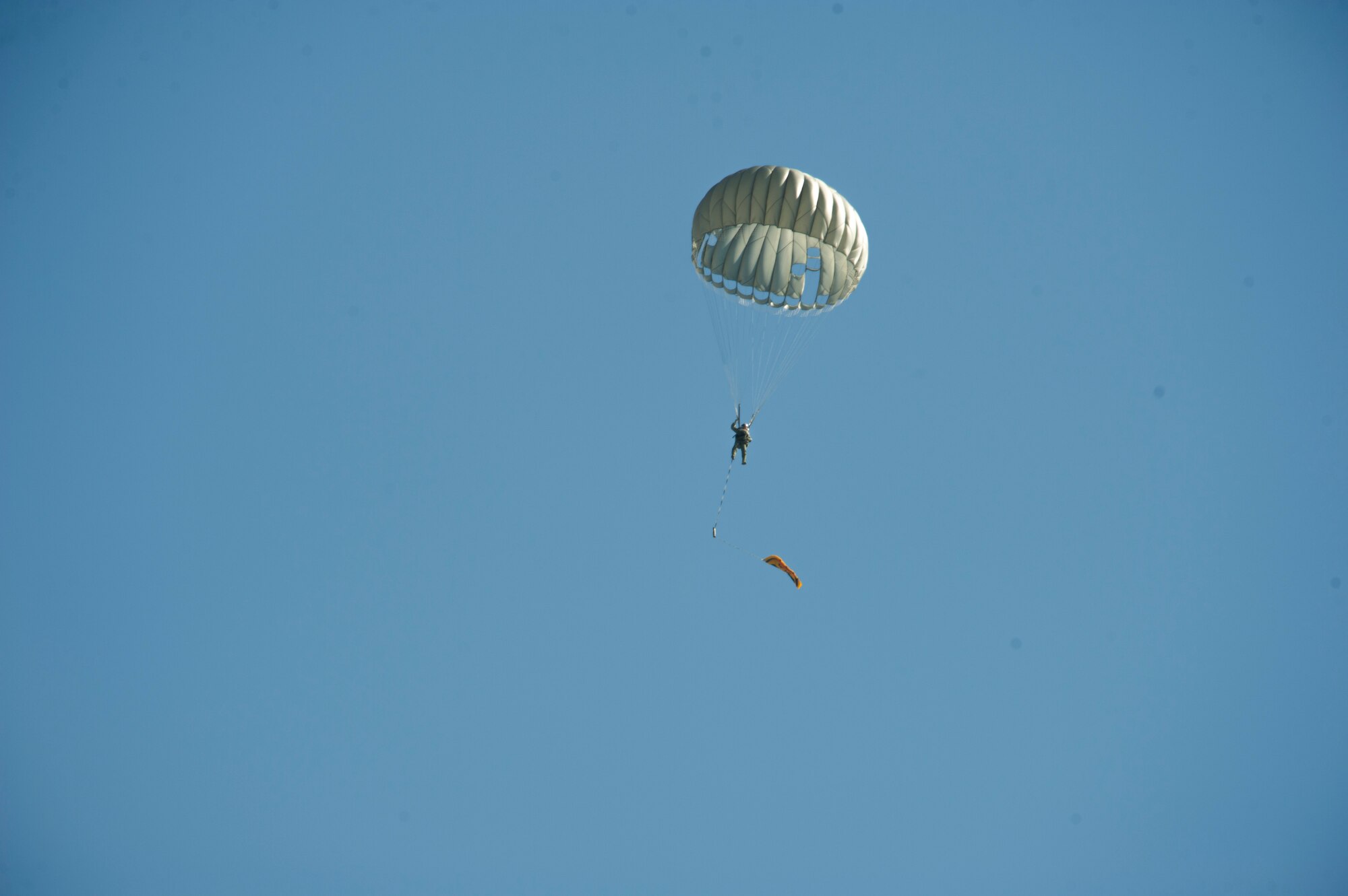 Survival, Evasion, Resistance and Escape specialists jump from a UH-1N Iroquois helicopter operated by the 36th Rescue Squadron during a parachute demonstration Sept. 29, 2015, at Fairchild Air Force Base, Wash. SERE specialists demonstrated the safety of parachuting from airframes during an Air Education and Training Command civic leader visit to the SERE School. The visit showcased the SERE career field to Lt. Gen. Darryl Roberson, Air Education and Training Command commander, and AETC civic leaders. (U.S. Air Force photo/Airman 1st Class Nick J. Daniello)