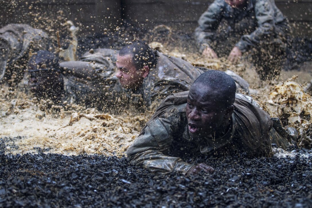 Soldiers in their second week of basic combat training low crawl through the final obstacle at the Fit to Win endurance course on Fort Jackson, S.C., Oct. 1, 2015. U.S. Army photo by Sgt. 1st Class Brian Hamilton