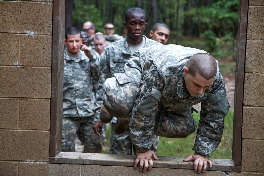 Soldiers in their second week of basic combat training line up to leap through the window obstacle at the Fit to Win endurance course on Fort Jackson, S.C., Oct. 1, 2015. U.S. Army photo by Sgt. 1st Class Brian Hamilton