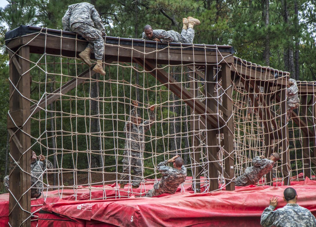 Soldiers in their second week of basic combat training climb up and over the cargo net obstacle at the Fit to Win endurance course on Fort Jackson, S.C., Oct. 1, 2015. U.S. Army photo by Sgt. 1st Class Brian Hamilton