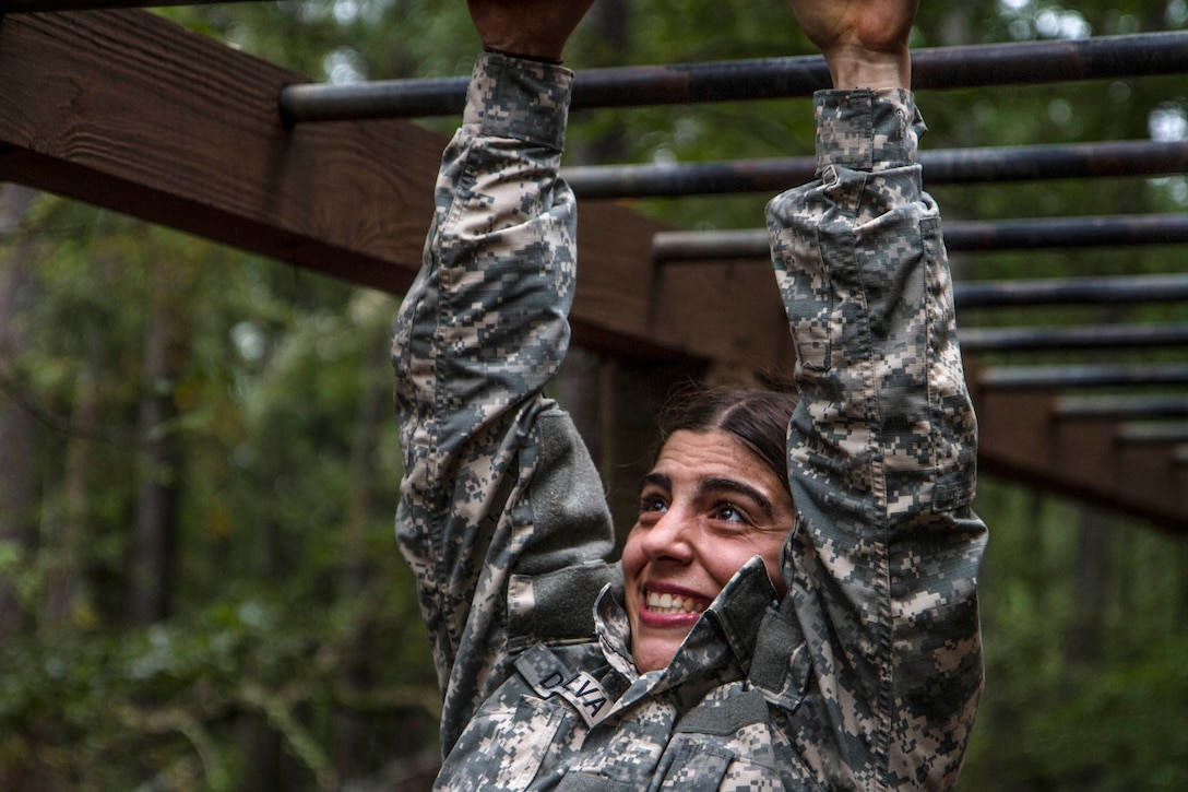 Army Pvt. Vanessa DaSilva, in her second week of basic combat training, tackles the monkey bars during the Fit to Win endurance course on Fort Jackson, S.C., Oct. 1, 2015. DaSilva is assigned to Company B, 3rd Battalion, 34th Infantry Regiment. U.S. Army photo by Sgt. 1st Class Brian Hamilton