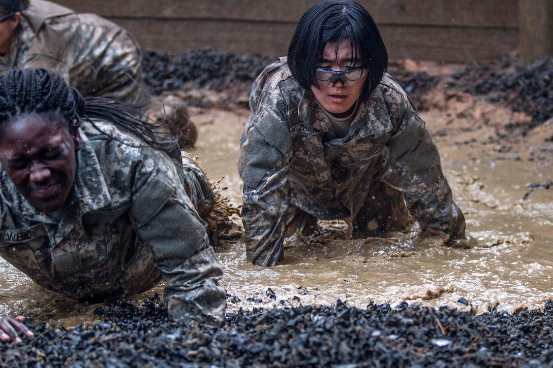Army Pvt. Tanica Marco in her second week of basic combat training makes her way through the final water obstacle at the Fit to Win endurance course on Fort Jackson, S.C., Oct. 1, 2015. Marco is assigned to Company B, 3rd Battalion, 34th Infantry Regiment. U.S. Army photo by Sgt. 1st Class Brian Hamilton