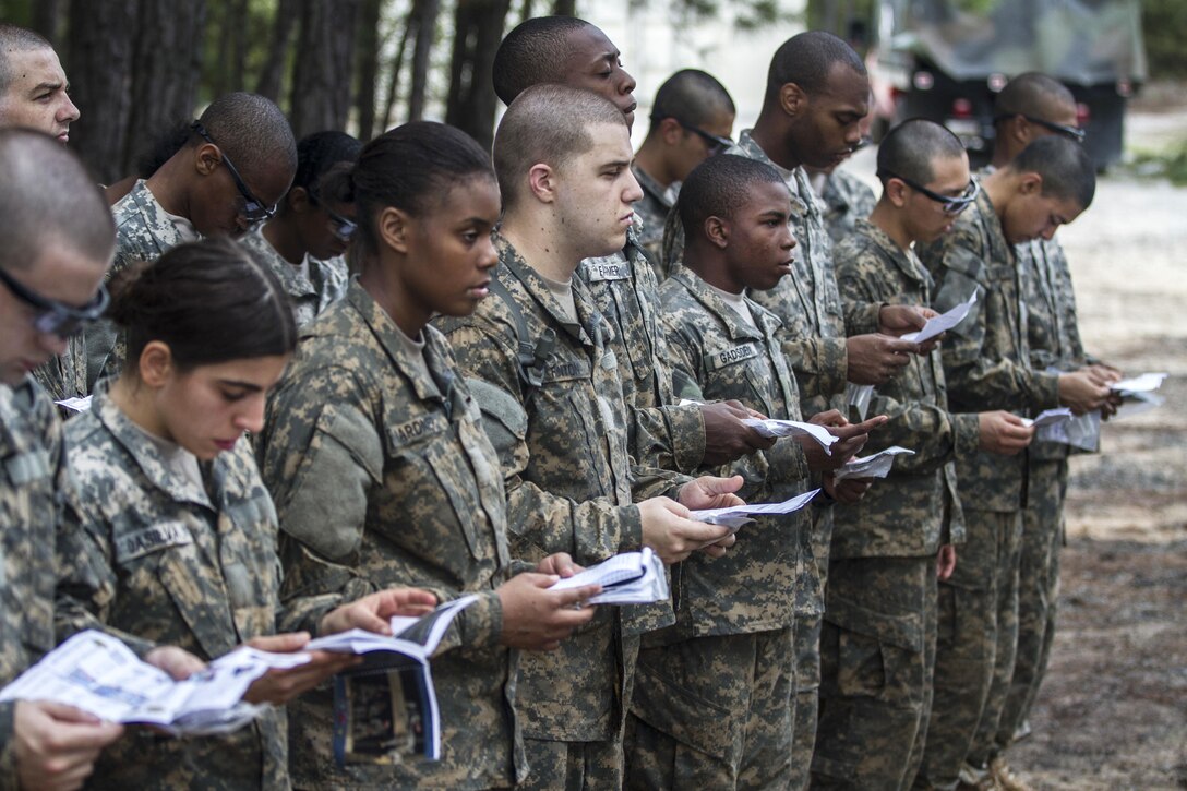 Soldiers in their second week of basic combat training study their smart books while waiting for their battle buddies to finish the super squad challenge at the Fit to Win endurance course on Fort Jackson, S.C., Oct. 1, 2015. U.S. Army photo by Sgt. 1st Class Brian Hamilton